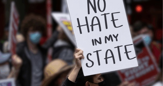 Protest against hate crimes with sign that says 